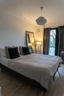 a bedroom with a large bed with a large mirror at luxusowy apartament w centrum Krakowa in Kraków