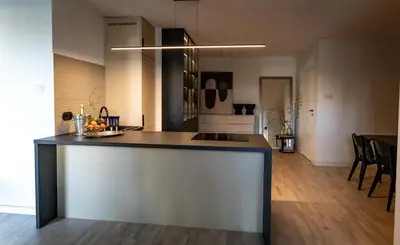 a kitchen with a island in the middle of a room at luxusowy apartament w centrum Krakowa in Kraków