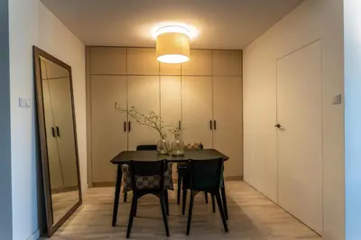 a dining room with a table and chairs and a mirror at luxusowy apartament w centrum Krakowa in Kraków