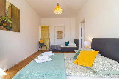 a living room with a couch and a bed at Alma in Cracow! 2 room by the gate to Old Town in Kraków