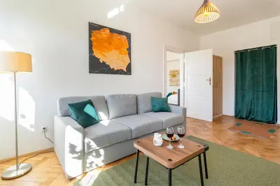 a living room with a couch and a table at Alma in Cracow! 2 room by the gate to Old Town in Kraków