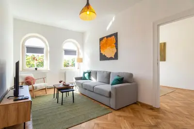 a living room with a couch and a table at Alma in Cracow! 2 room by the gate to Old Town in Kraków