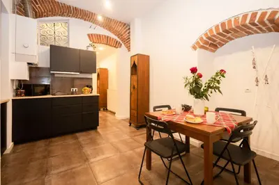 a kitchen with a table and a dining room at ARTEon with terrace in Kraków