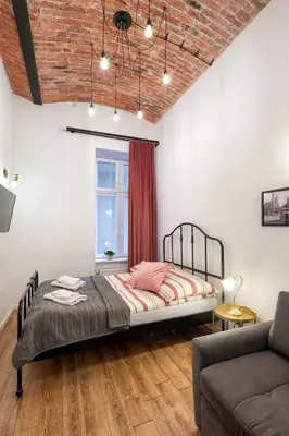 a bathroom with a white tub and a toilet at ATLAS apartment in the center in Kraków