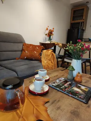 a living room with a wooden table with two cups on it at MICHAŁÓWKA - Domek w Górach przy Lesie - Energylandia in Targanice