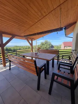 a large wooden table and benches on a patio at Widokowy zakątek niedaleko Energylandi Zator in Zator