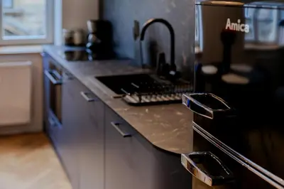 a kitchen with a counter top with a sink at Colourful apartments Siemiradzkiego Street - City Centre in Kraków