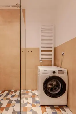 a washing machine in a room with a glass door at Colourful apartments Siemiradzkiego Street - City Centre in Kraków