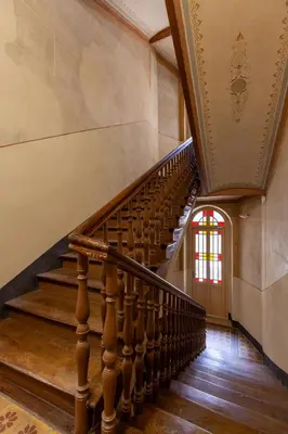 a spiral staircase in a building with a window at Colourful apartments Siemiradzkiego Street - City Centre in Kraków