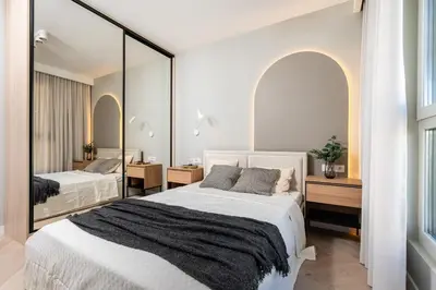 a bedroom with two beds and a mirror at Sandstone Apartament - homfi Collection in Kraków
