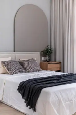 a white bed with a black blanket on top of it at Sandstone Apartament - homfi Collection in Kraków