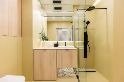 a bathroom with a sink and a shower at Sandstone Apartament - homfi Collection in Kraków
