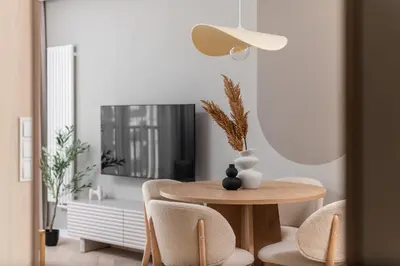 a table and chairs in a room with a mirror at Sandstone Apartament - homfi Collection in Kraków