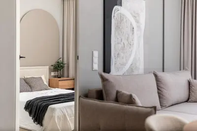 a bedroom with a bed and a couch and a mirror at Sandstone Apartament - homfi Collection in Kraków