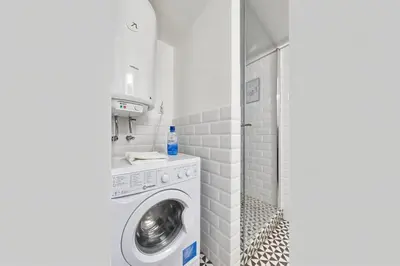 a laundry room with a washing machine and a shower at Cracow Fancy Brick #2 - Old Town in Kraków