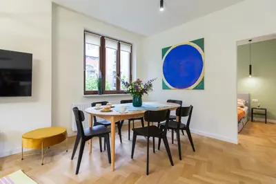a bedroom with a bed with colorful sheets at Golden hour, 2 bedroom, with underground parking in Kraków