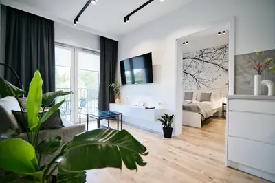 a living room with a bed and a mirror at Jaśminowy Las by Housine in Zator