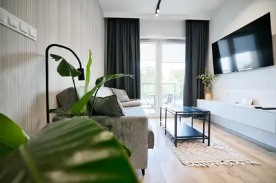 a living room with a couch and a table at Jaśminowy Las by Housine in Zator