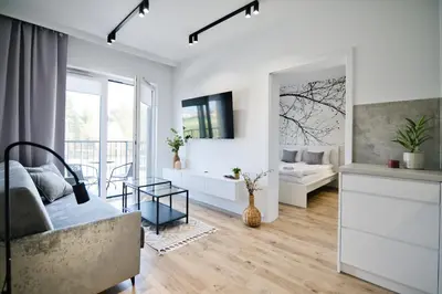 a living room with a couch and a mirror at Jaśminowy Las by Housine in Zator