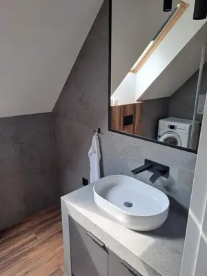 a bathroom with a sink and a mirror at Domek letniskowy Leśne Zacisze in Słopnice