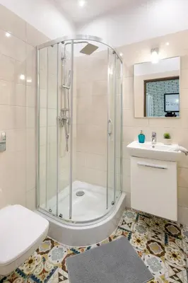 a bathroom with a shower and a toilet and a sink at Mint&Jade studio B in Kraków
