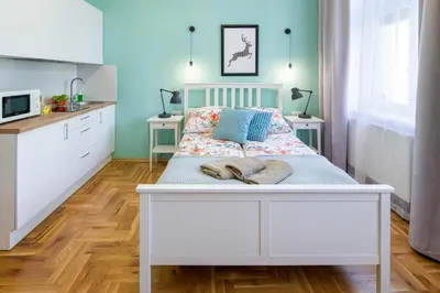 a bedroom with a bed with two towels on it at Mint&Jade studio B in Kraków