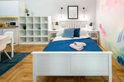 a bedroom with a white bed with towels on it at Mint&Jade studio C in Kraków