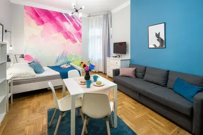 a living room with a couch and a table at Mint&Jade studio C in Kraków