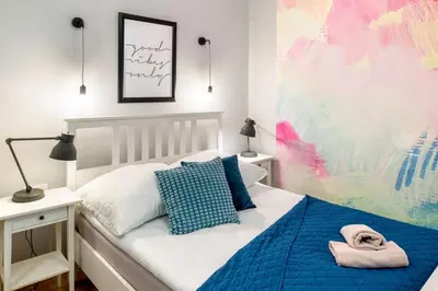 a bedroom with a bed with a blue blanket at Mint&Jade studio C in Kraków