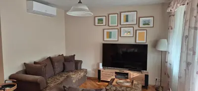 a living room with a couch and a flat screen tv at Apartment with terrace and garage in Kraków