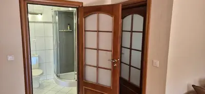 a bathroom with a shower and a glass door at Apartment with terrace and garage in Kraków