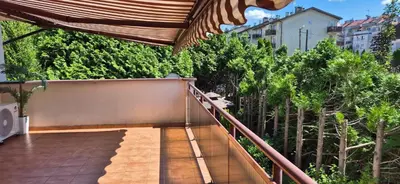 a balcony with a staircase leading up to some trees at Apartment with terrace and garage in Kraków