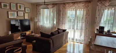 a living room with a couch and a television at Apartment with terrace and garage in Kraków