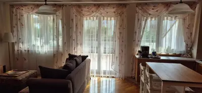 a living room with a couch and large windows at Apartment with terrace and garage in Kraków