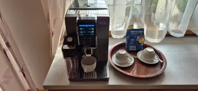 a coffee machine sitting on a counter next to a plate at Apartment with terrace and garage in Kraków
