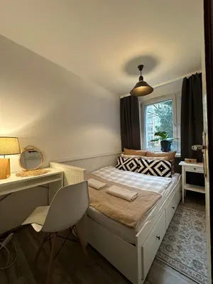 a bedroom with a bed with a desk and a window at Pokój z parkingiem 20 minut piechotą od Rynku Głównego i Dworca Głównego in Kraków