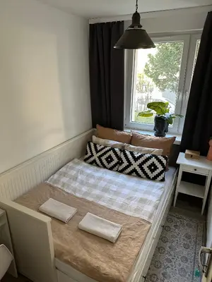 a bed with two pillows on it in a room at Pokój z parkingiem 20 minut piechotą od Rynku Głównego i Dworca Głównego in Kraków