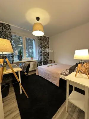 a bedroom with a bed and a desk and two lamps at Pokój z parkingiem 20 minut piechotą od Rynku Głównego i Dworca Głównego in Kraków