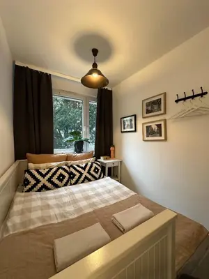 a bedroom with a large bed in front of a window at Pokój z parkingiem 20 minut piechotą od Rynku Głównego i Dworca Głównego in Kraków