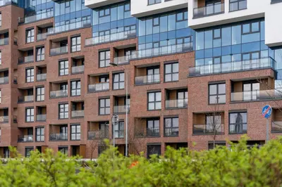 a tall brick building with many windows at Malila Premium Apartments Cracow Rakowicka 20L- 453 in Kraków