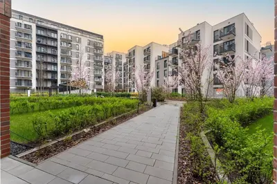 a walkway in a city with apartment buildings at Malila Premium Apartments Cracow Rakowicka 20L- 453 in Kraków