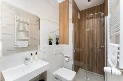 a bathroom with a shower and a toilet and a sink at Malila Premium Apartments Cracow Rakowicka 20L- 453 in Kraków