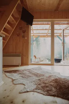 a living room with a couch and a wood stove at Domki pod Halą Krupową - Chata na szlaku in Sidzina