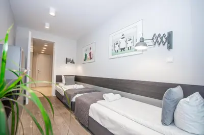 a living room with a couch and a tv at Family Apartment with 2 bedrooms, huge balcony, Free parking, 10 minutes walk to Main Square and Kazimierz District in Kraków