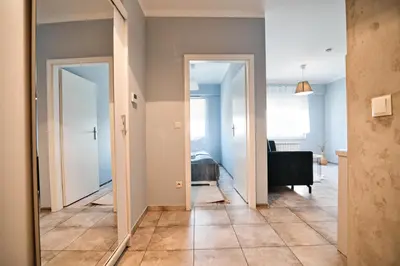 a hallway with two doors leading to a bedroom at ApartClaudia by Housine in Zator