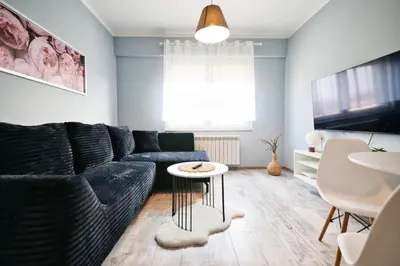 a living room with a couch and a table at ApartClaudia by Housine in Zator