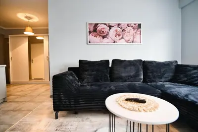 a living room with a black couch and a table at ApartClaudia by Housine in Zator