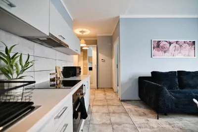 a kitchen and living room with a couch at ApartClaudia by Housine in Zator