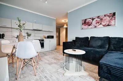 a living room with a black couch and a table at ApartClaudia by Housine in Zator