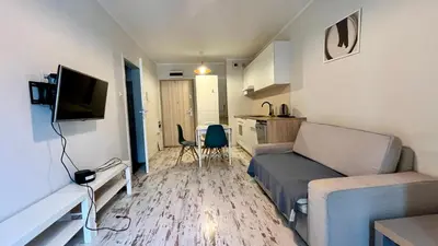 a bathroom with a washing machine and a sink and a toilet at Ślusarska Street in Kraków